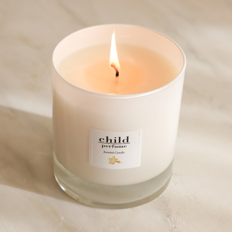 Child Perfume Scented Candle (8 oz) shown lit