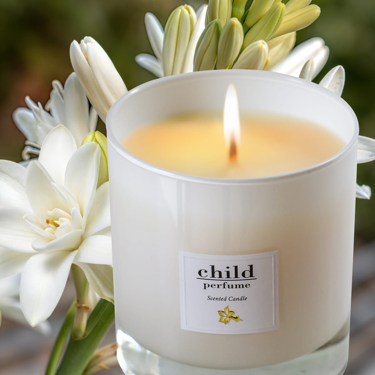 Child Perfume Candle (8 oz) with white flowers in the background