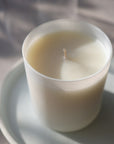 Lifestyle shot of Child Perfume Scented Candle 8 oz shown top angle view on white dish